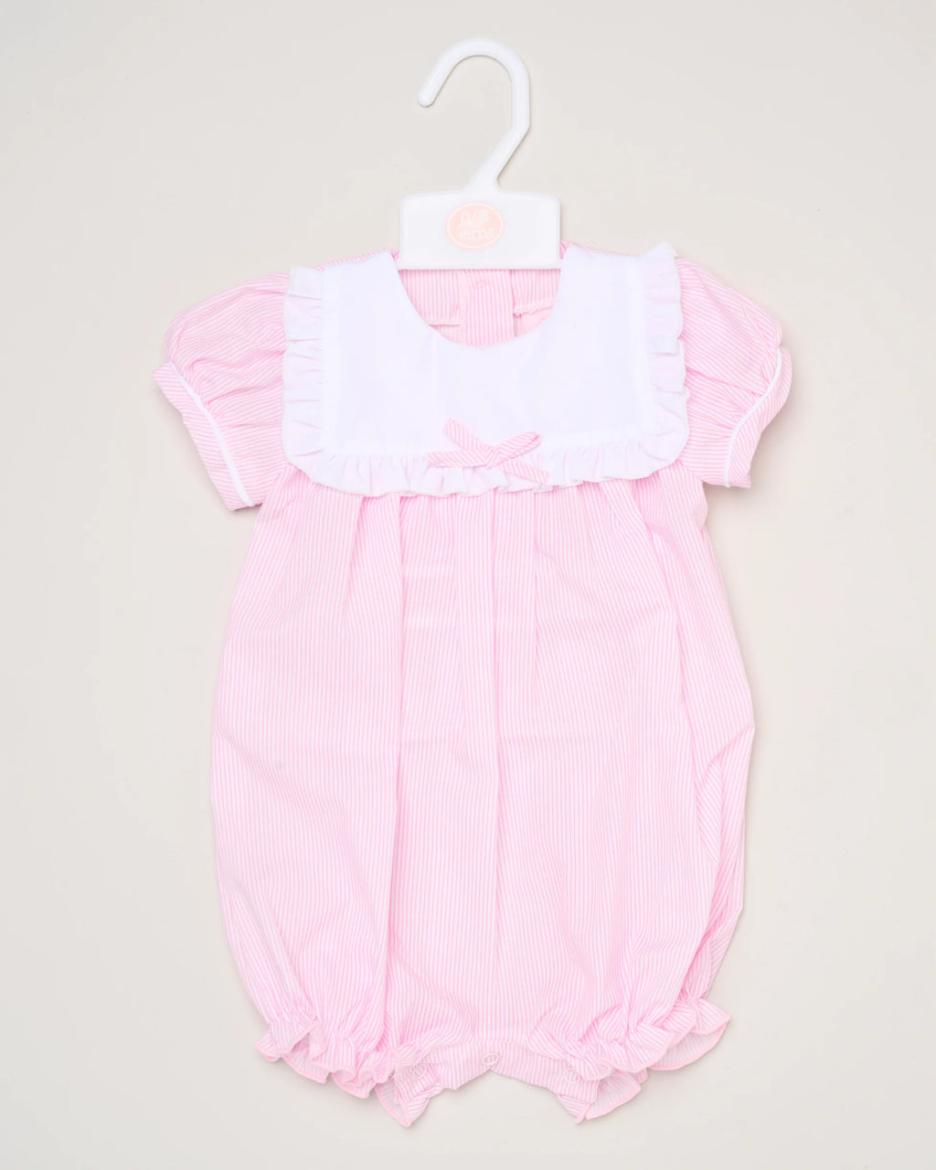 The Baby Girls Smocked Romper features pink and white stripes, short puff sleeves, a white ruffled collar, and a small front bow. It is shown on a white hanger against a plain background.