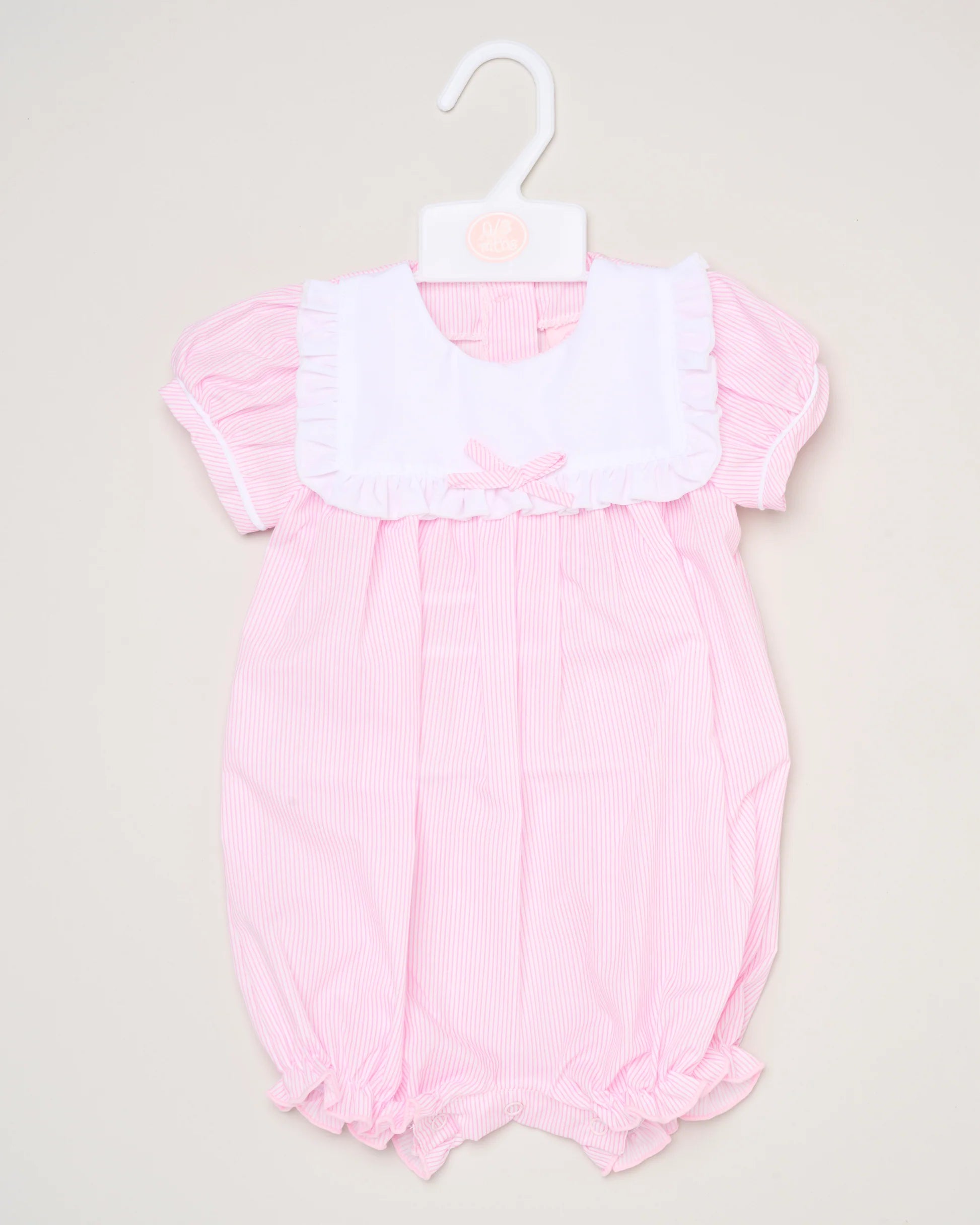 The Baby Girls Smocked Romper features pink and white stripes, short puff sleeves, a white ruffled collar, and a small front bow. It is shown on a white hanger against a plain background.