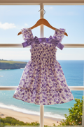 Purple heart dress on hanger with sea view